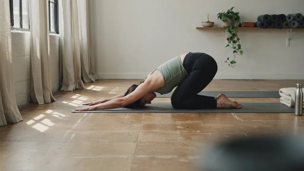Person performing Extended Puppy Pose to release tension in the back and shoulders.