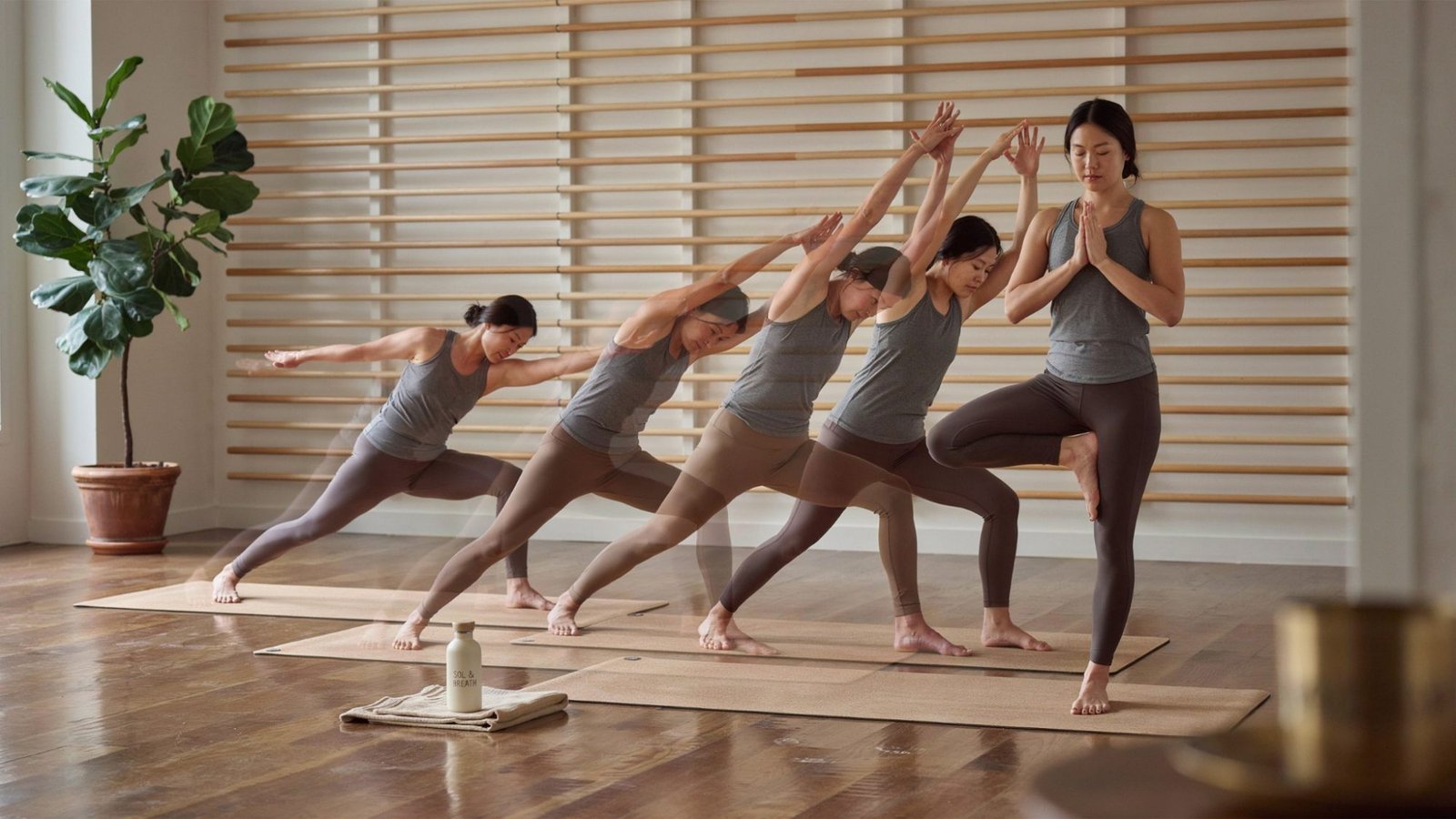 Continuous yoga movement flowing seamlessly through multiple poses in heated vinyasa.