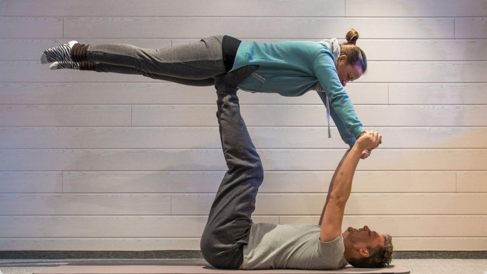 Flying bow is one of the Best Acro Yoga Poses for Beginners