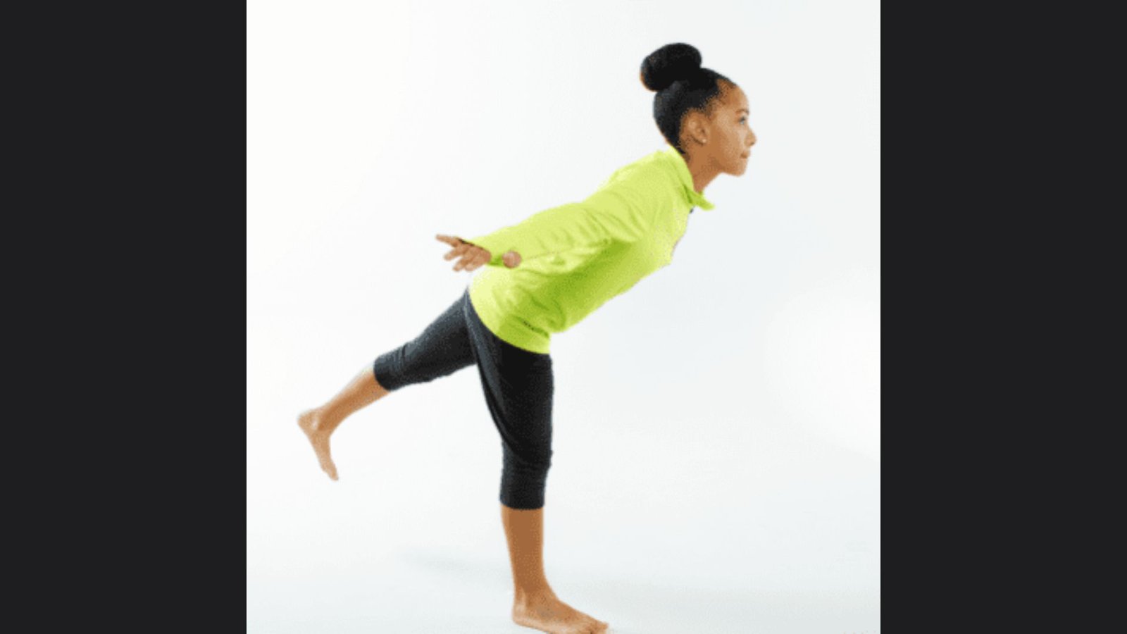 Single child performing classic Airplane yoga pose with flapping arms.