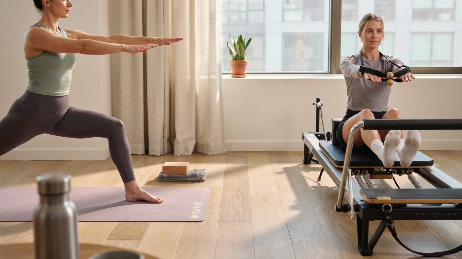 Realistic image of yoga vs pilates in the same workout room. Equipment vs natural workout routine.